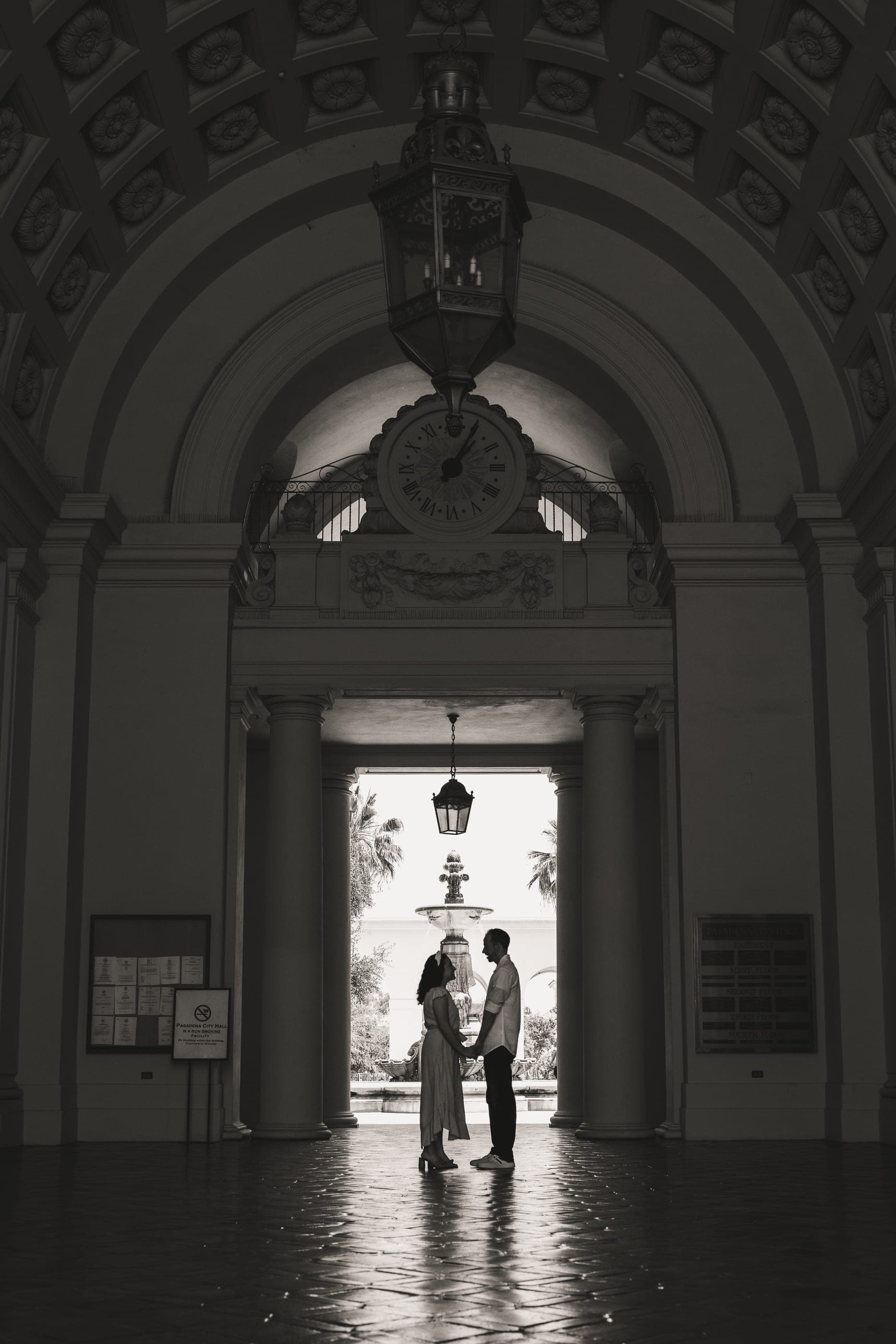 Engagement session under a grand archway