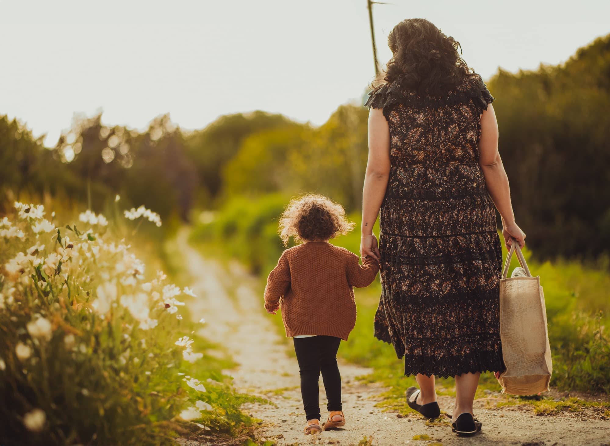 Mother and child walking a garden path