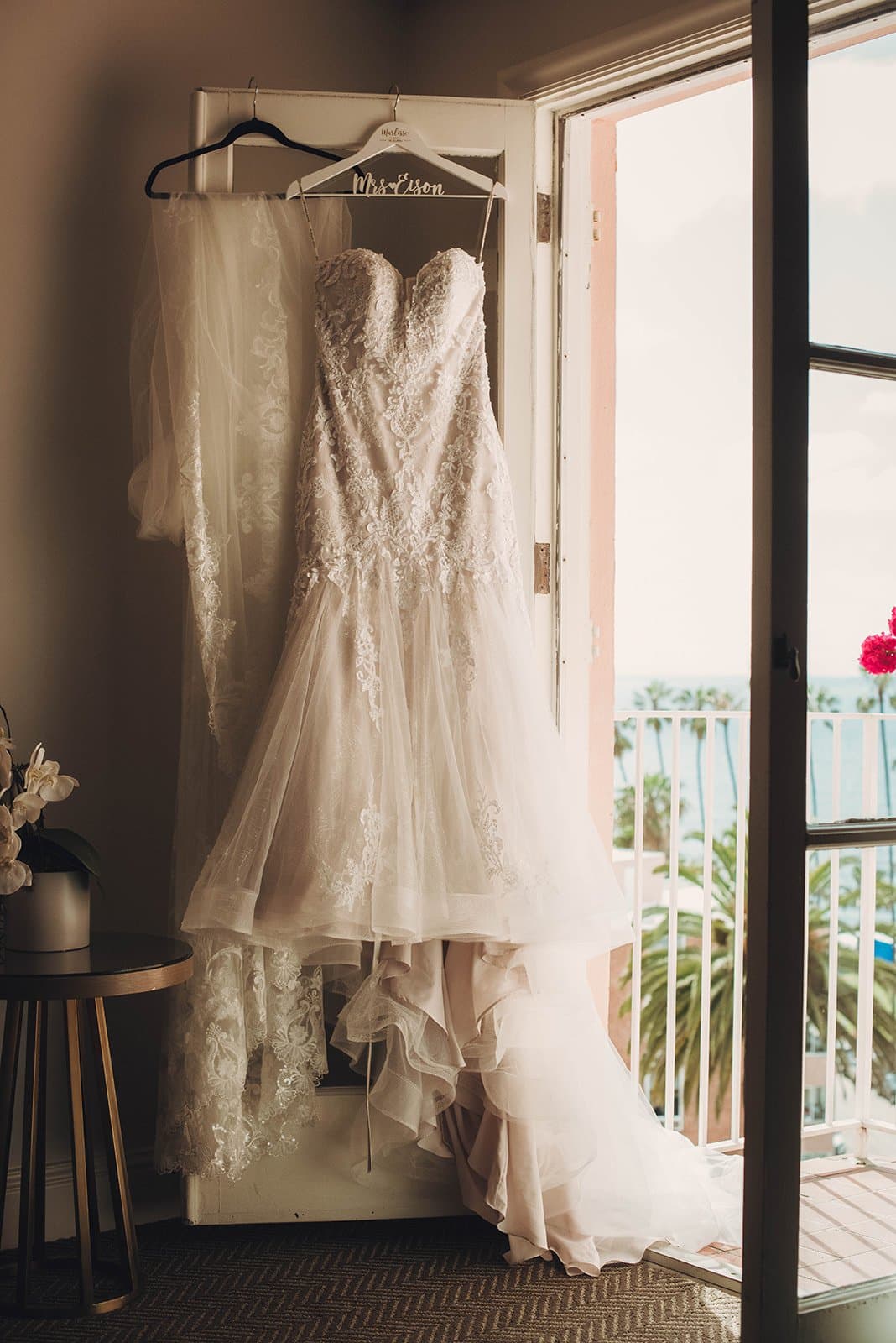 Wedding dress hanging by the window