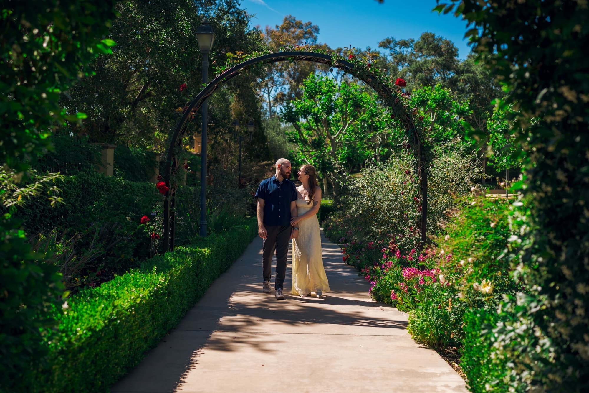 Engagement session under a garden arch
