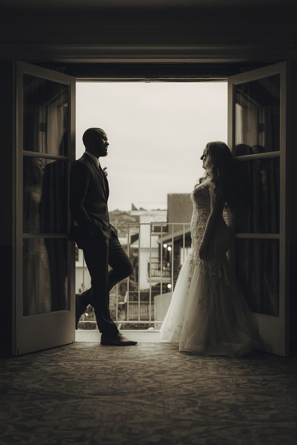 Bride and groom silhouetted in a doorway