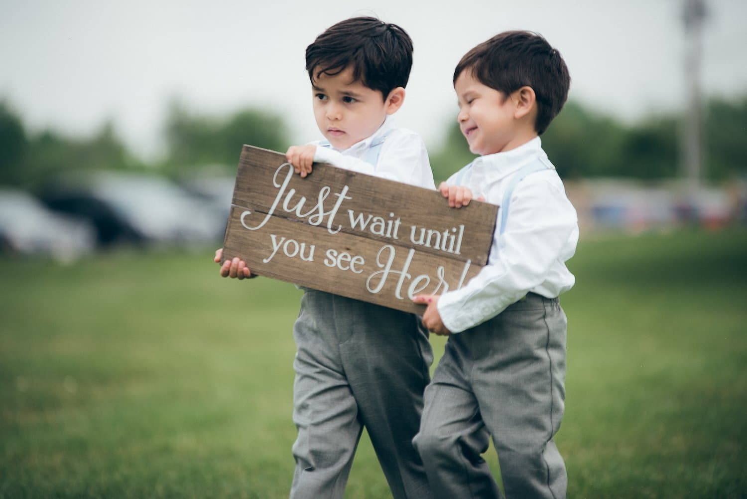 Ring bearers holding a sign